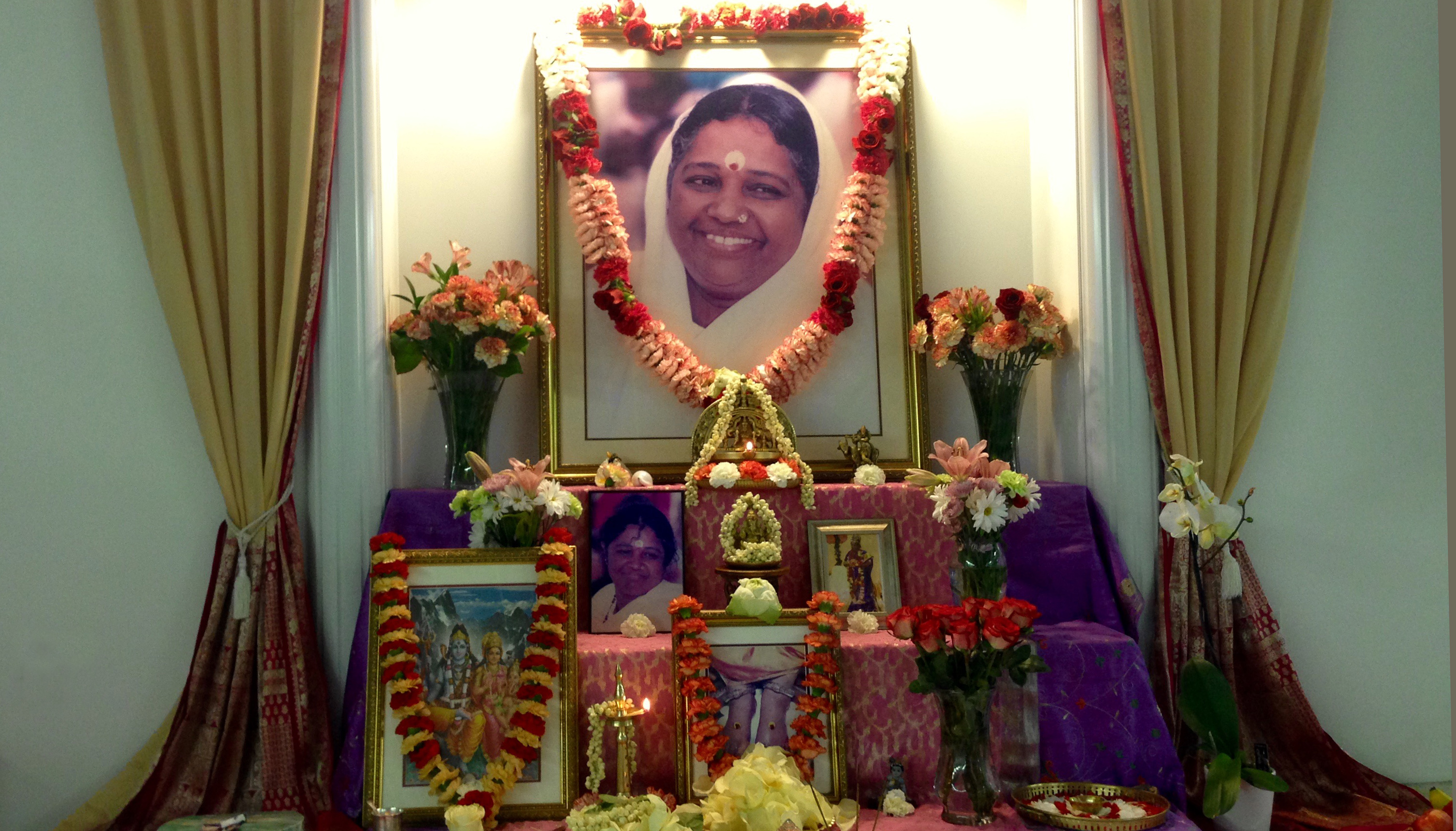 Altar with Amma's photo, garlands and fresh flowers