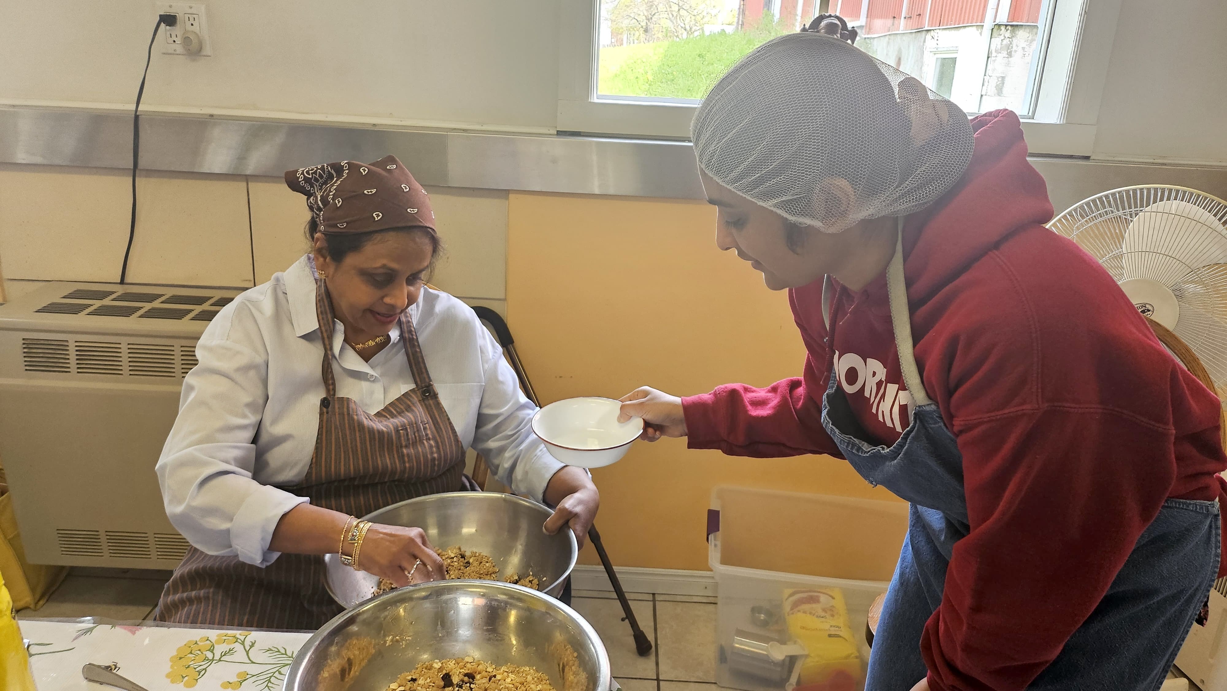 Volunteers mixing cookie dough
