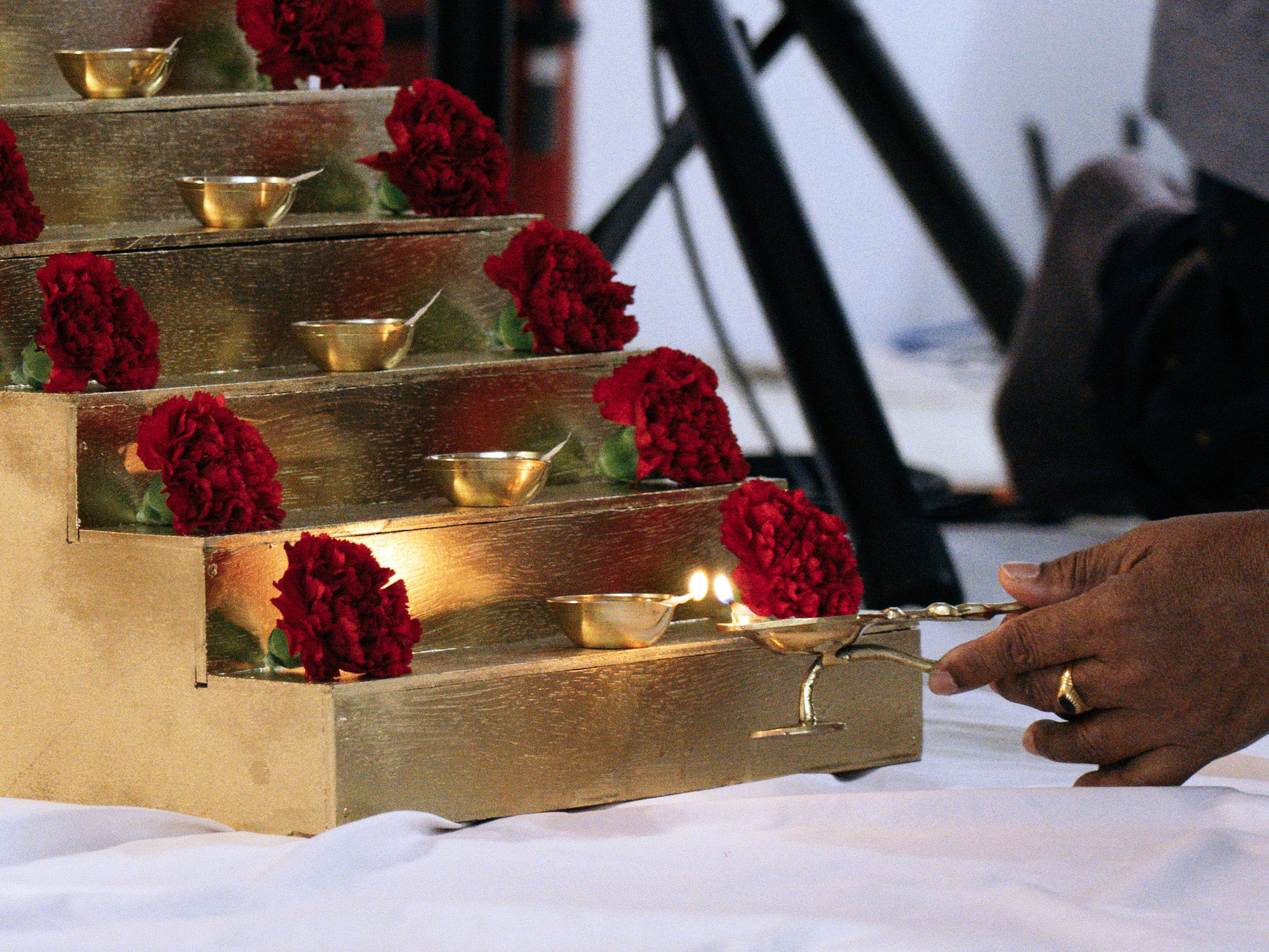 Devotee lighting lamp on golden steps