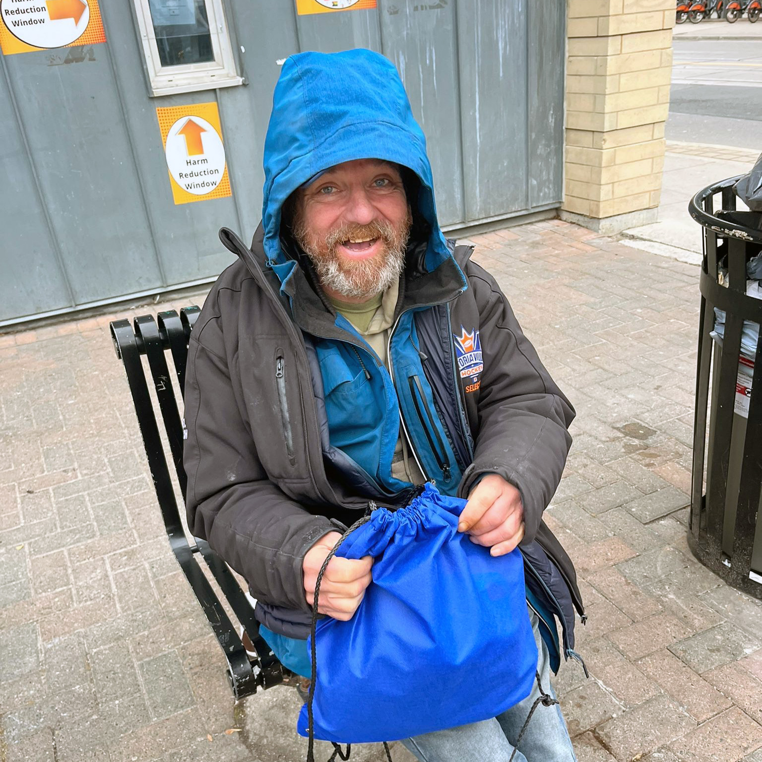 Smiling man holding care package