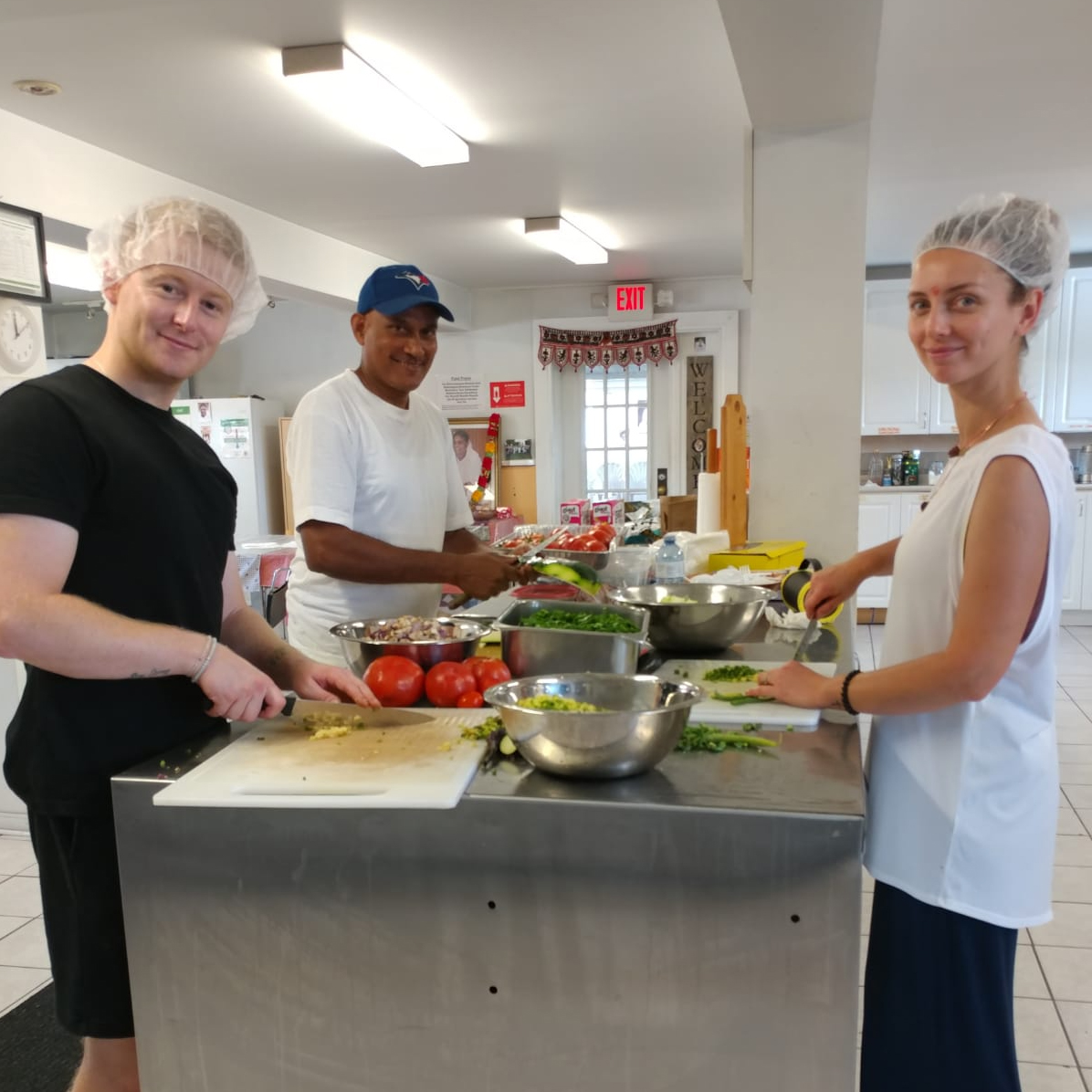 Volunteers chopping fresh veggies to make lunch