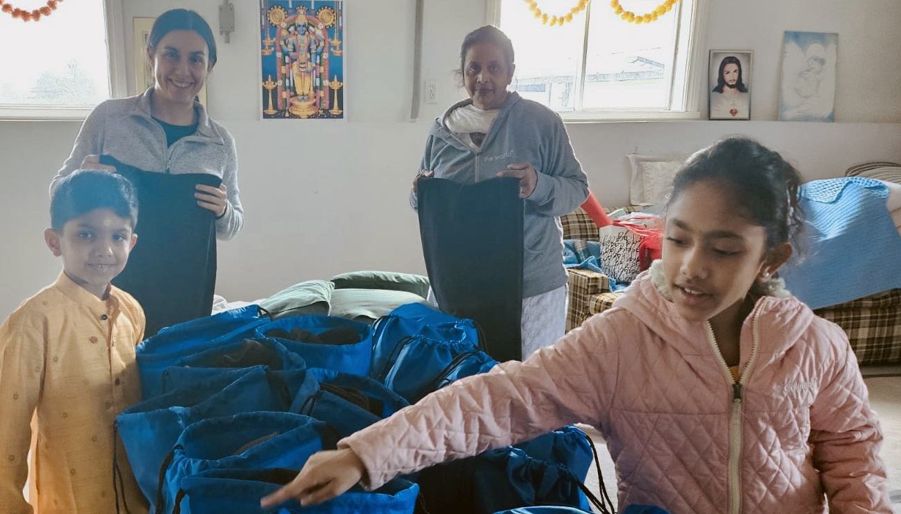 Volunteers packing warm socks, gloves, and toques into care packages for homeless people