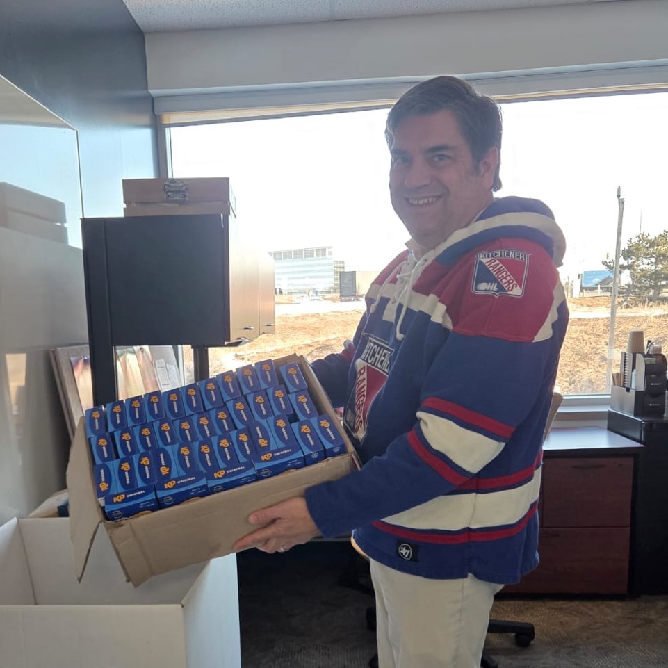 Food Bank volunteer with donated Kraft Dinner