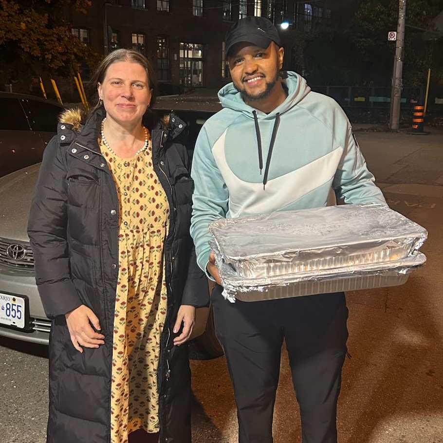 St. Felix staff members and Amma Canada volunteer holding trays of cookies from Amma Canada