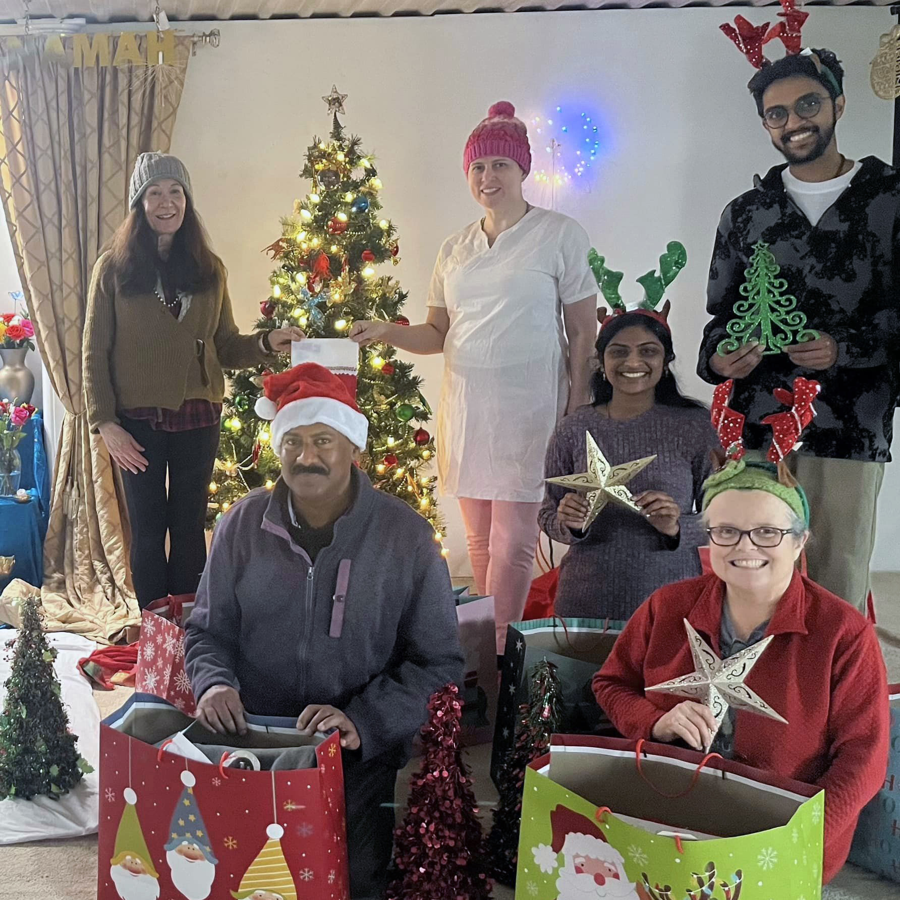 Toronto Satsang volunteers wrapping gifts for Links2Care clients