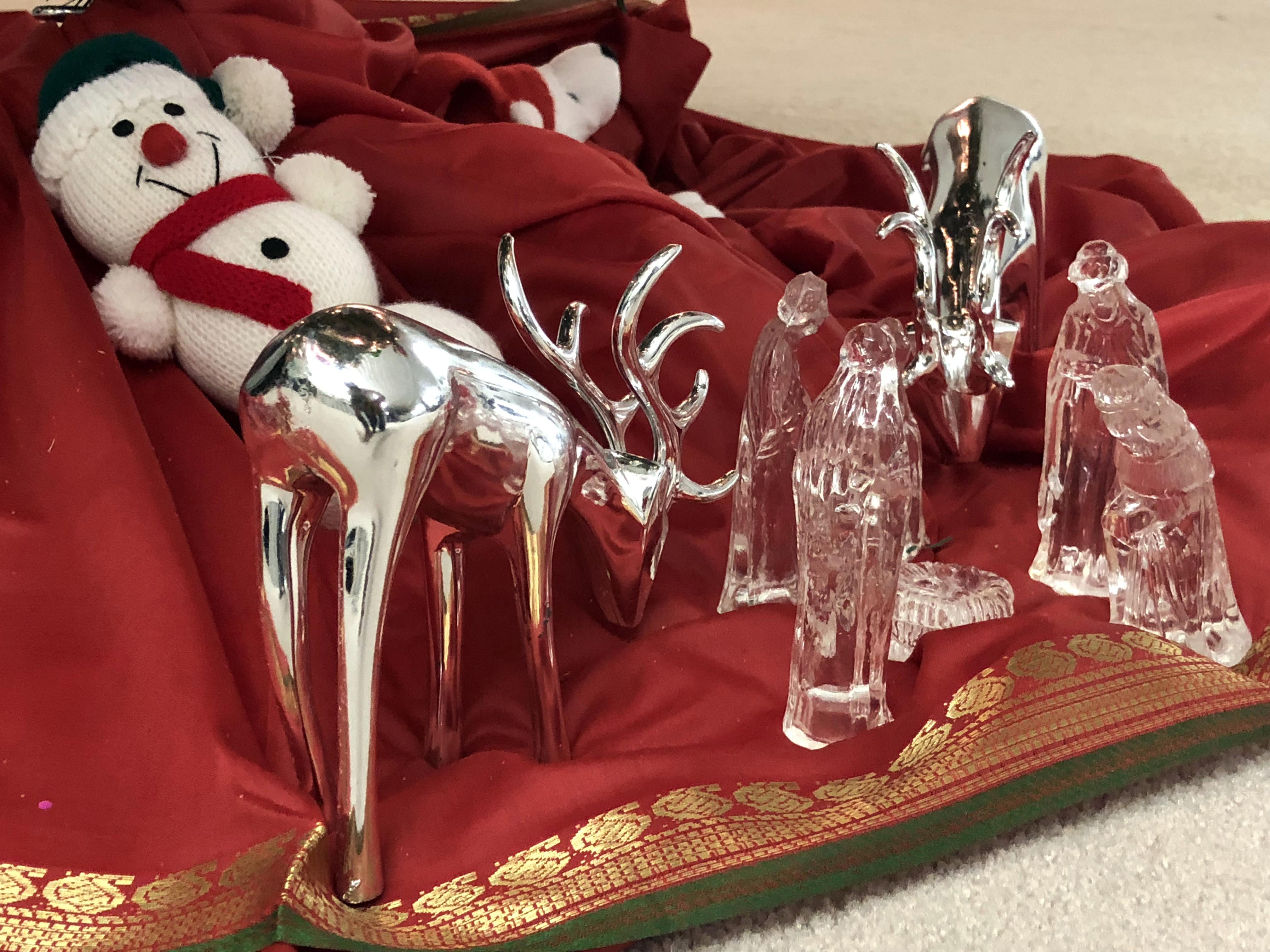 Glass nativity scene on red cloth