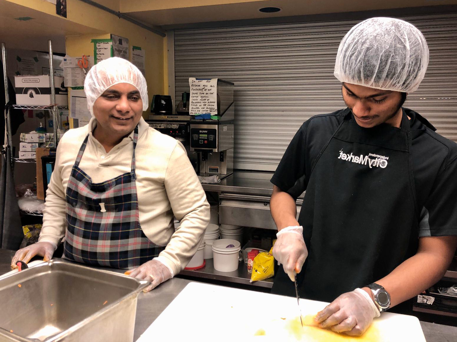 Two AYUDH members and mentor chopping together