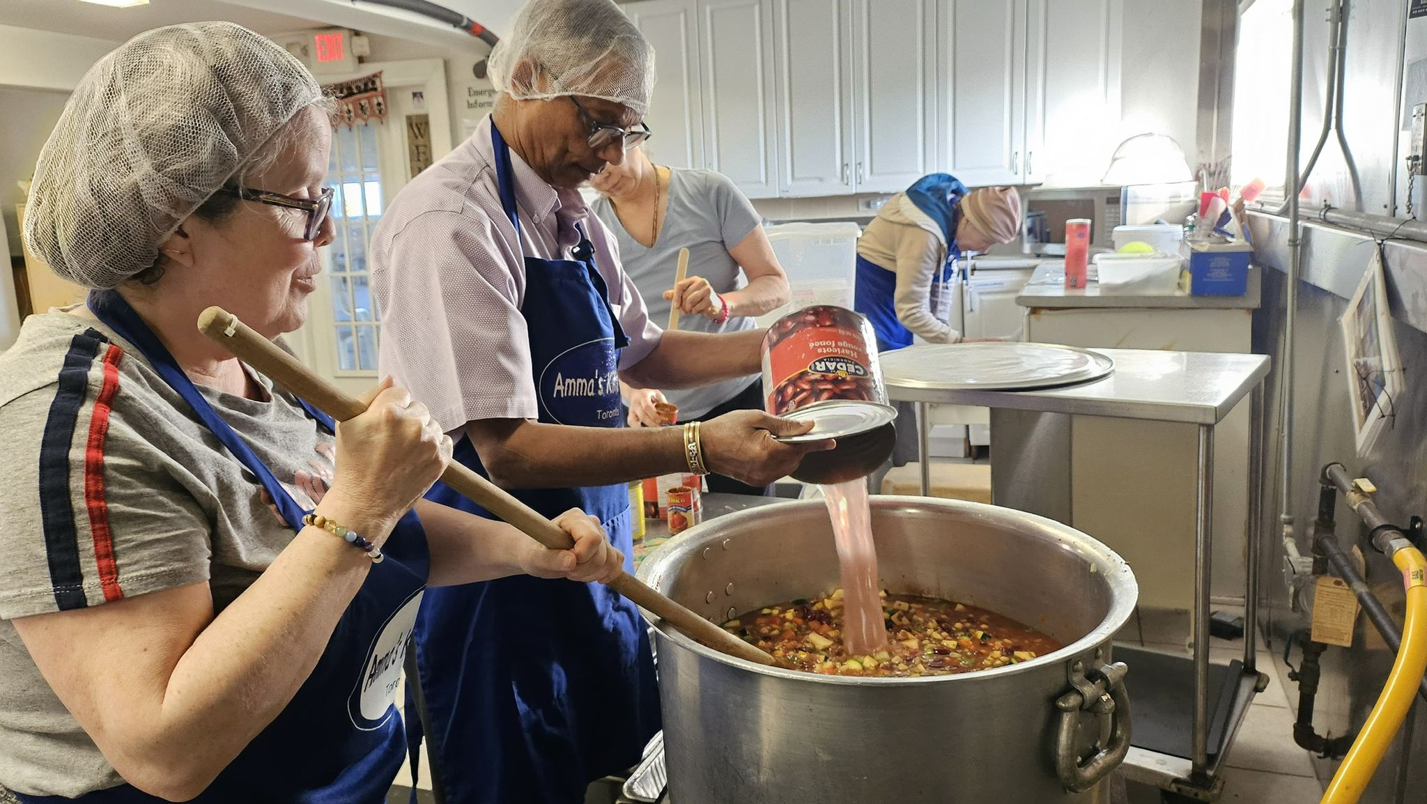 Pauline and Mohan Uncle mixing chilli