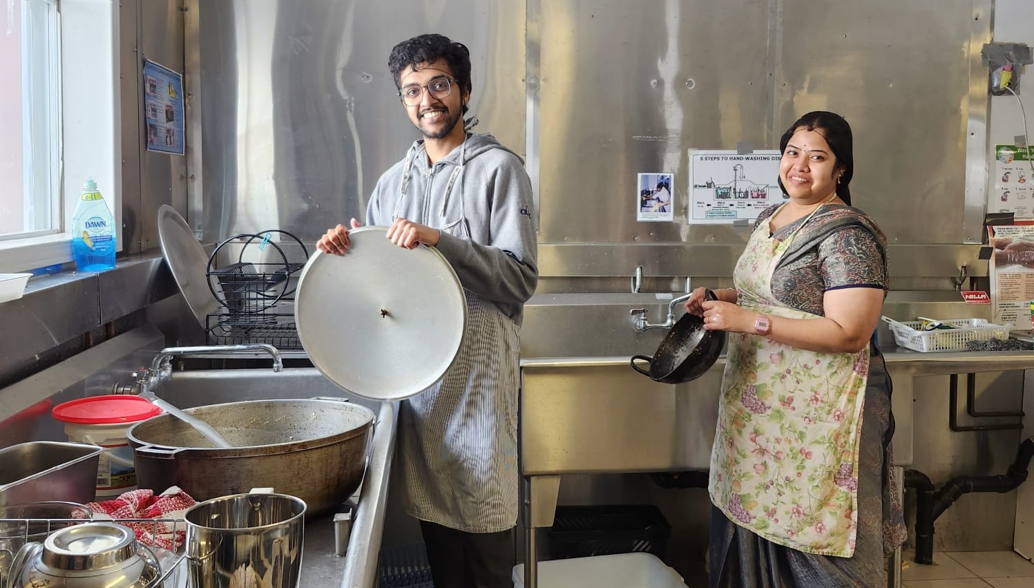 Shambhu and Varsha washing the pots