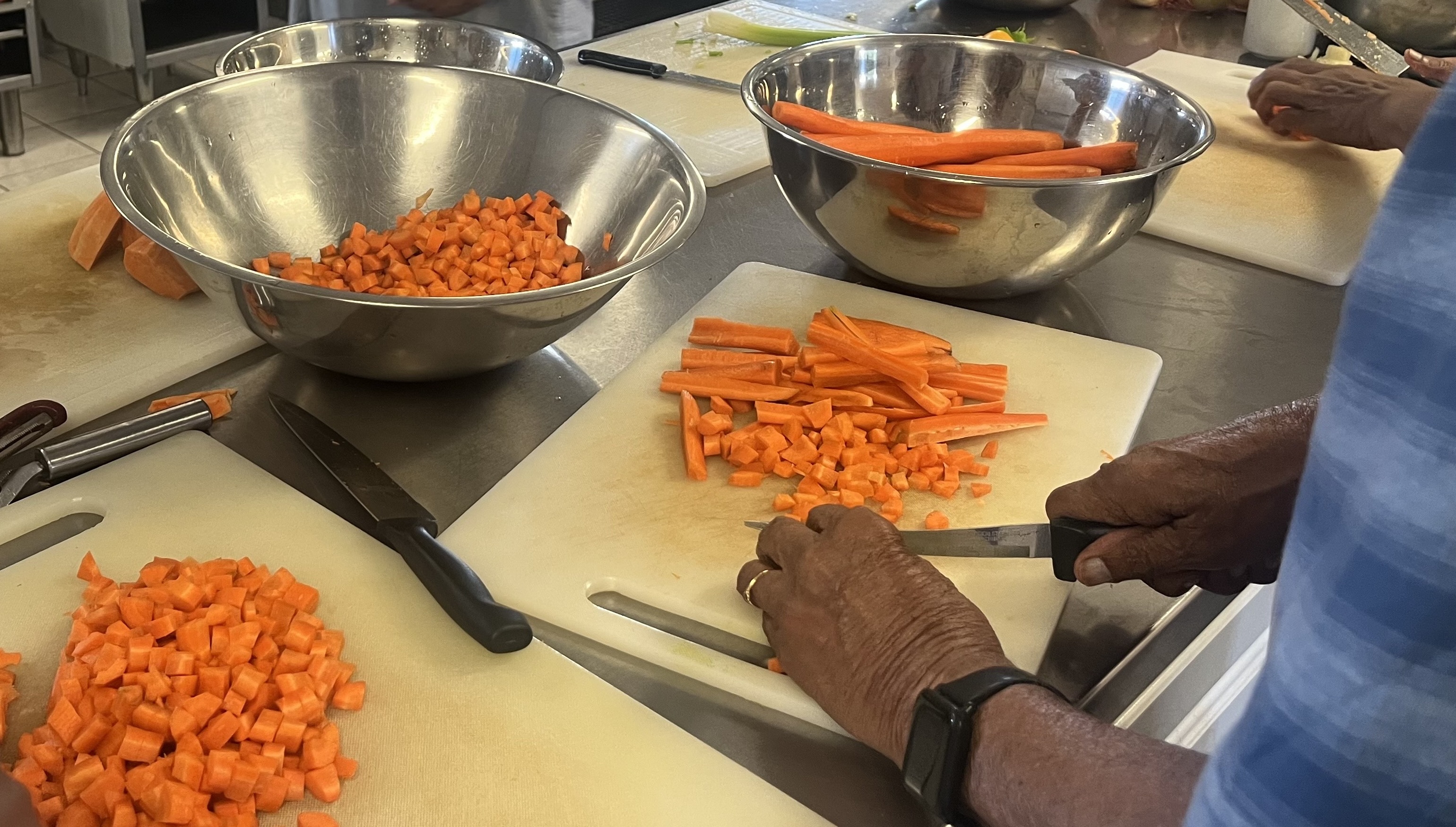 Volunteer chopping carrots