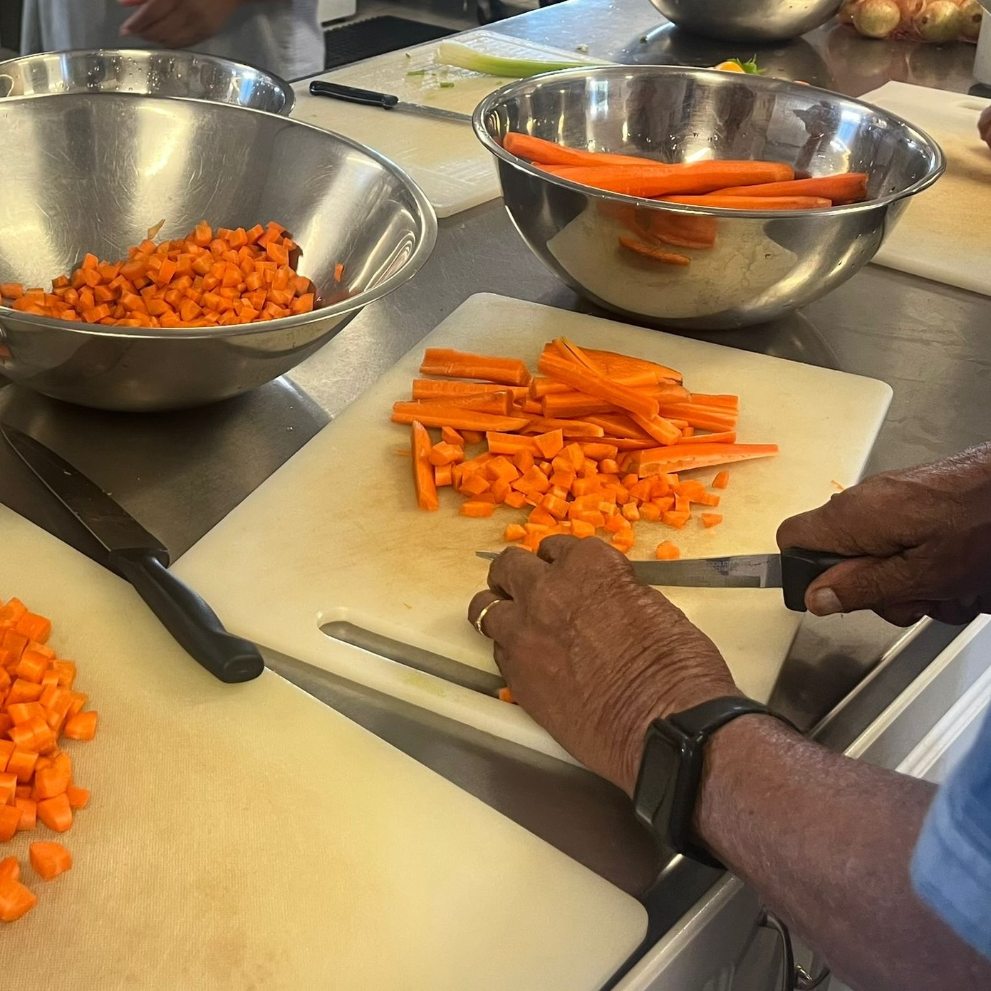 Volunteer chopping carrots