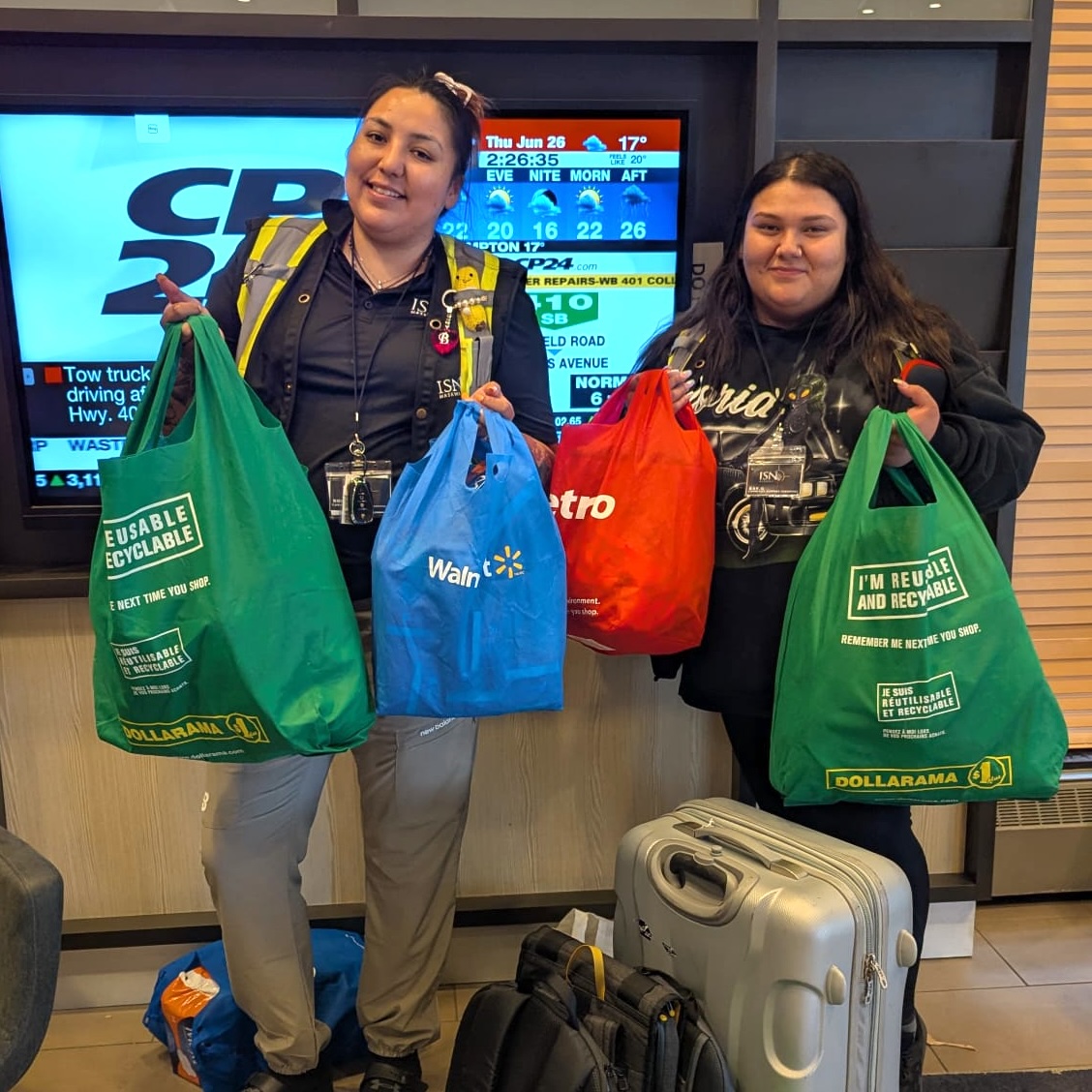 Volunteers holding bags of donated items