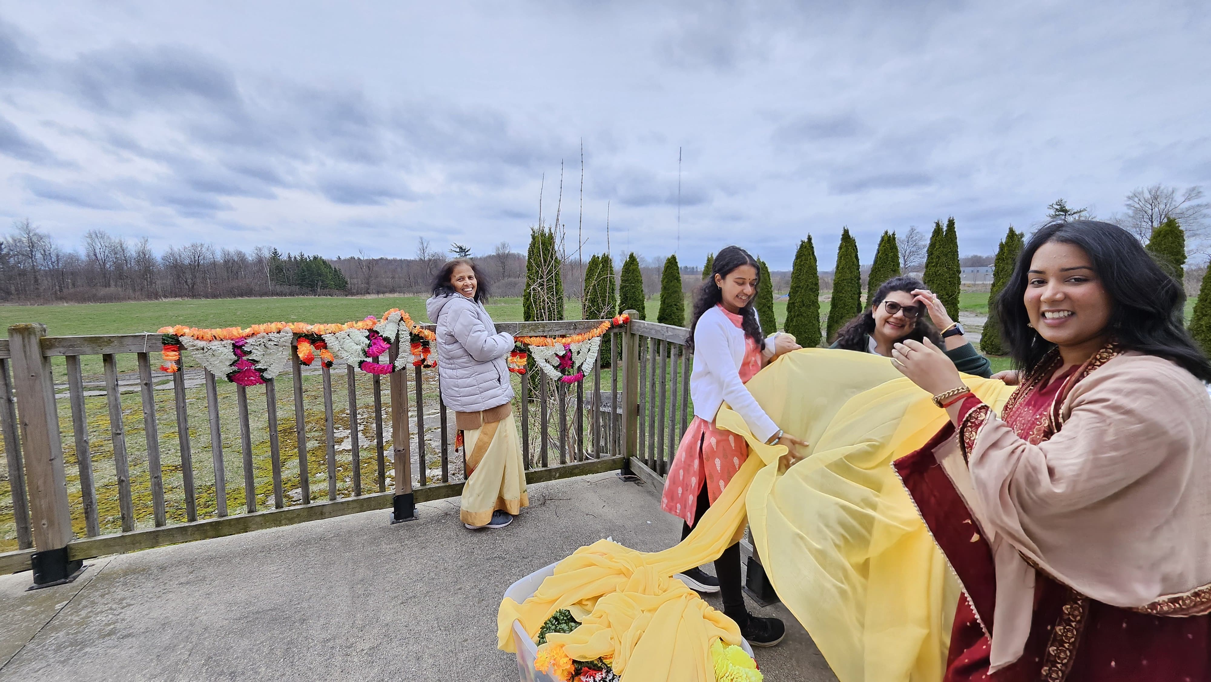 Devotees decorating the railing outside the hall with garlands