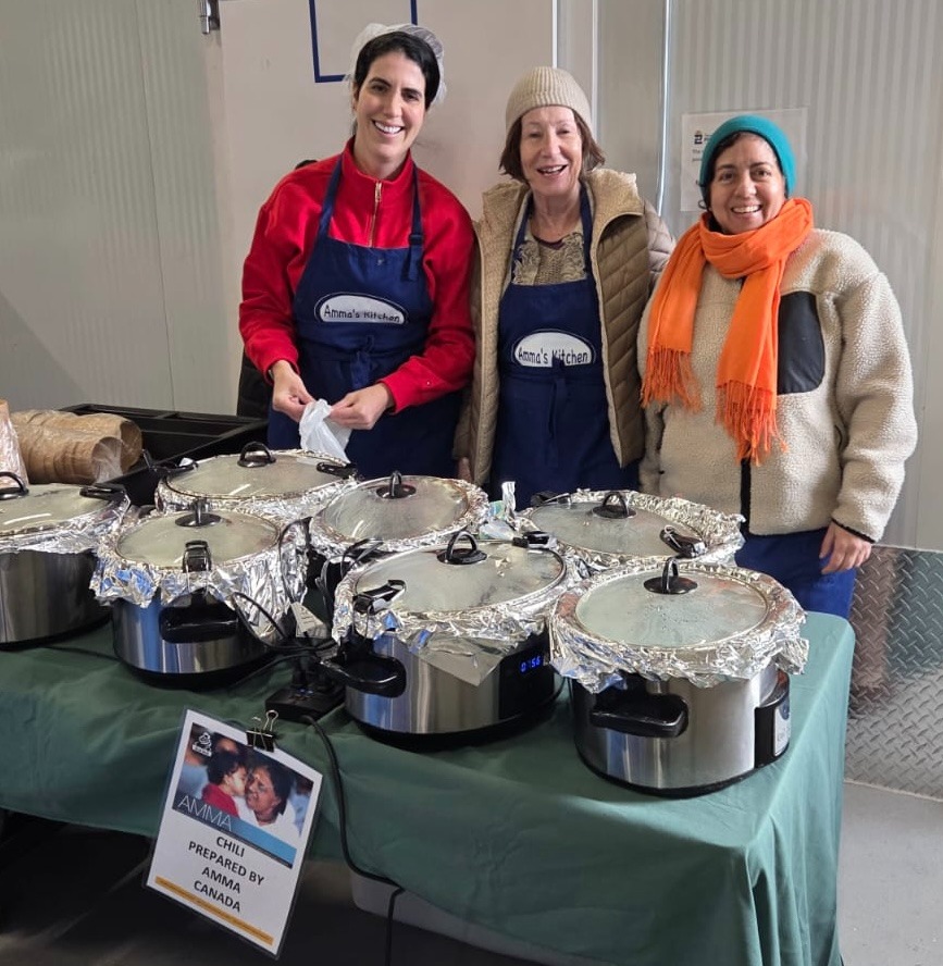 Three volunteers serving chilli at GBB